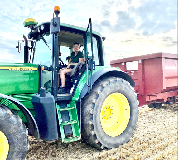 woman sat in green tractor
